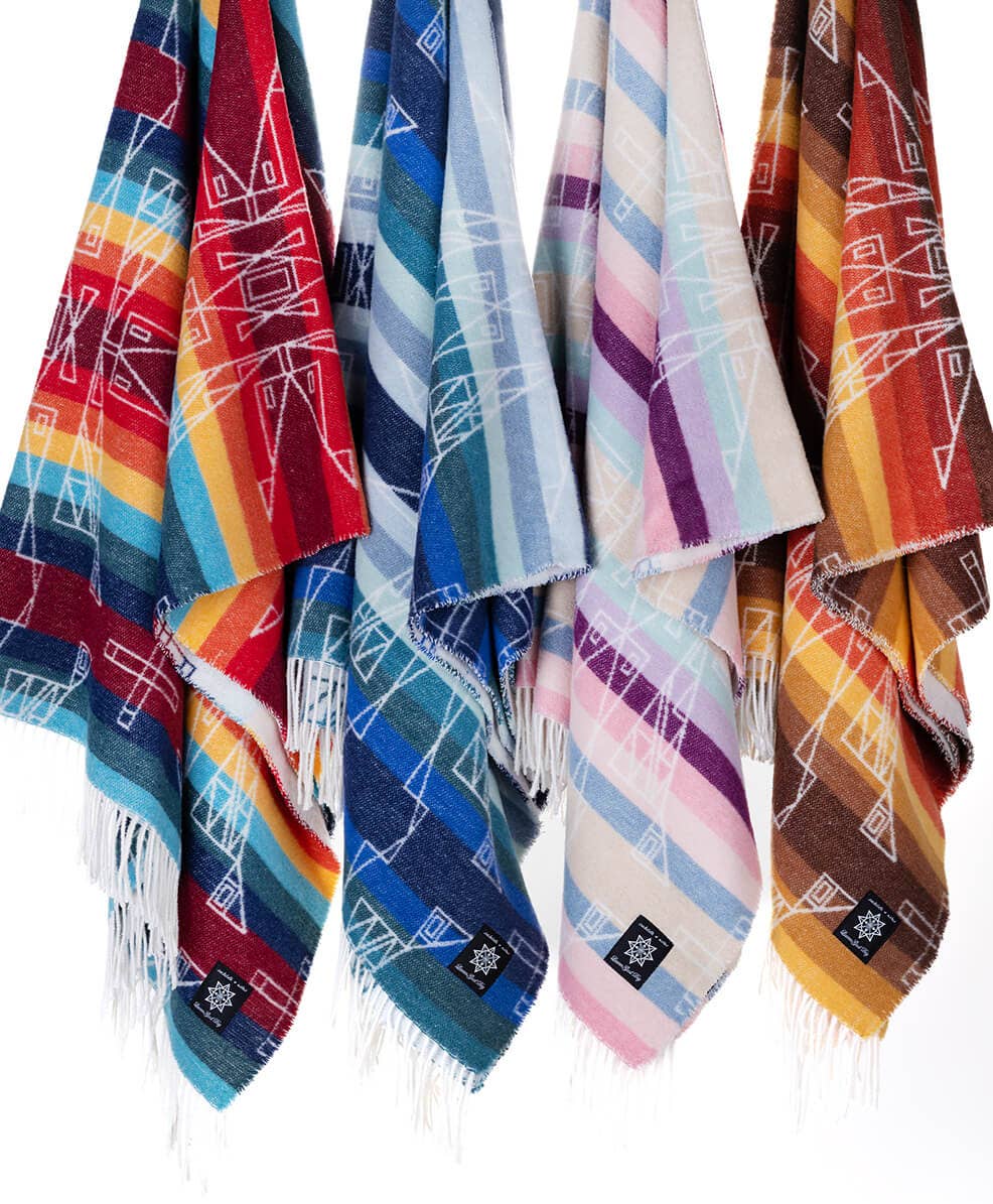 Textile artist Lauren Good Day's Seasons Designed blanket, Hunaaneeká (Spring), crafted from recycled materials in a sustainable process. Size: 72”l x 60”w. 50% Recycled Polycotton, 25% Recycled Polyester, 20% Recycled Wool, 5% Other Fabric. Care: Wash Cool, Gentle Cycle / Tumble Dry Low.