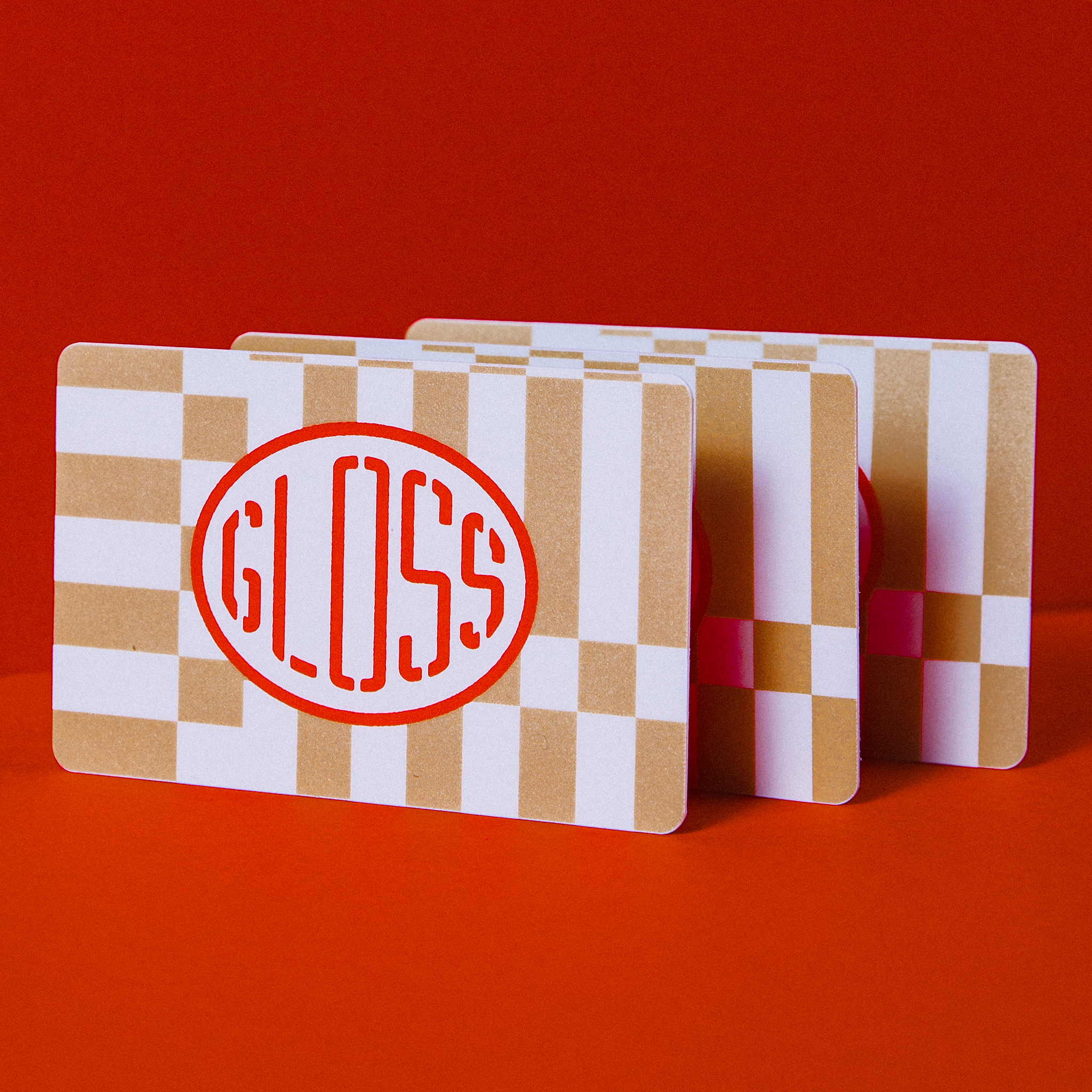 A deck of Gloss Loyalty Gift Cards displayed, featuring various designs like circles, stripes, and dots, emphasizing a stylish and versatile loyalty program option.