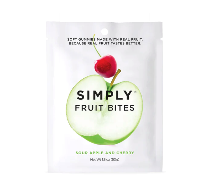 Close-up of Fruit Bites - Sour Apple & Cherry packaging with real fruit pieces, showcasing a white package featuring a green apple and a red cherry.