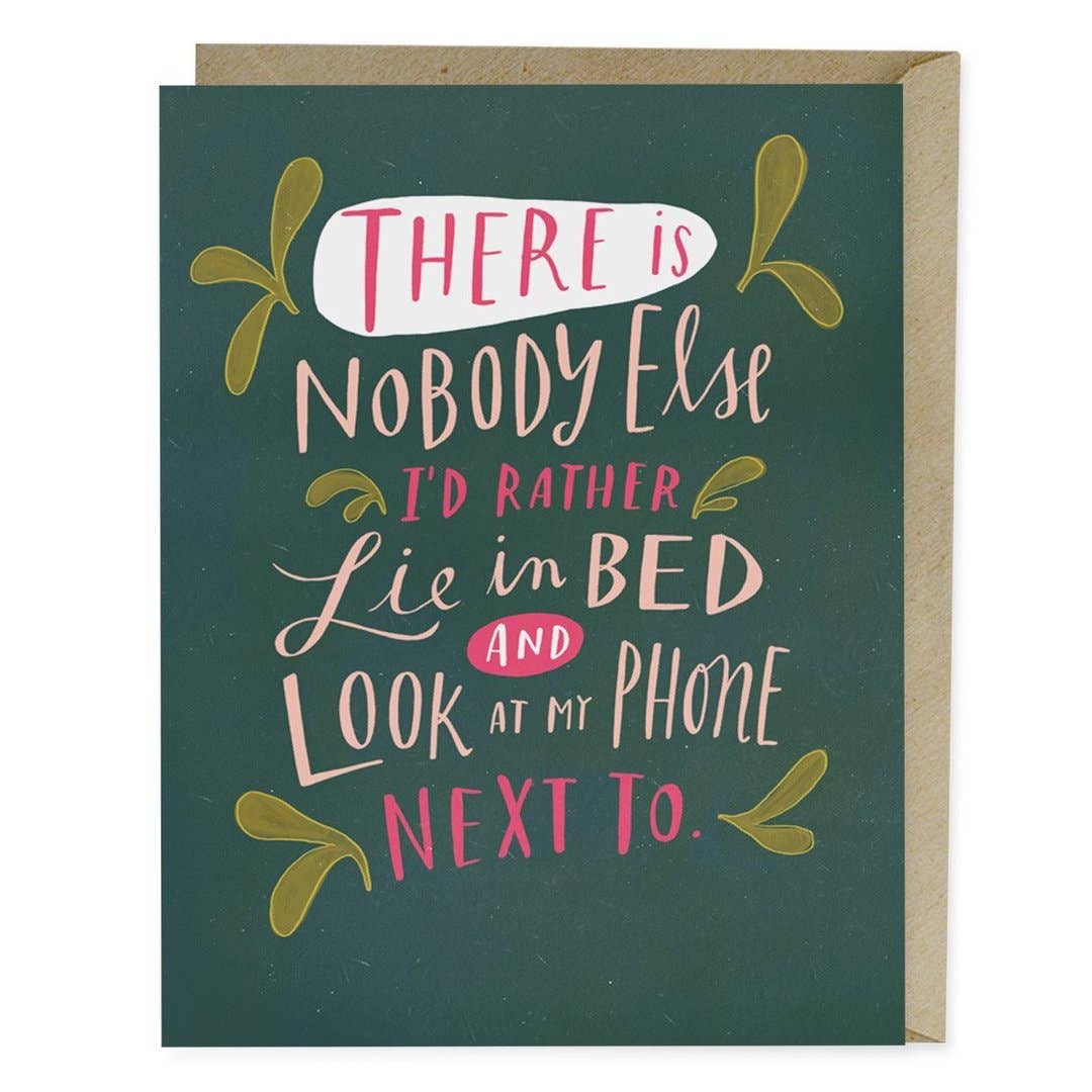 Em & Friends - Look at My Phone Love Card: A close-up of a sign on a green background, featuring handwritten text. Blank inside, A2 size, printed in the USA on matte stock, with a kraft envelope included.