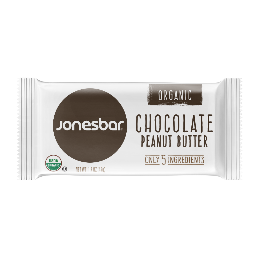 Organic Jonesbar Chocolate Peanut Butter Energy Bar 1.7oz with USDA certification. Gluten-free, vegan, perfect with coffee. Close-up of a white and brown chocolate peanut butter bar.