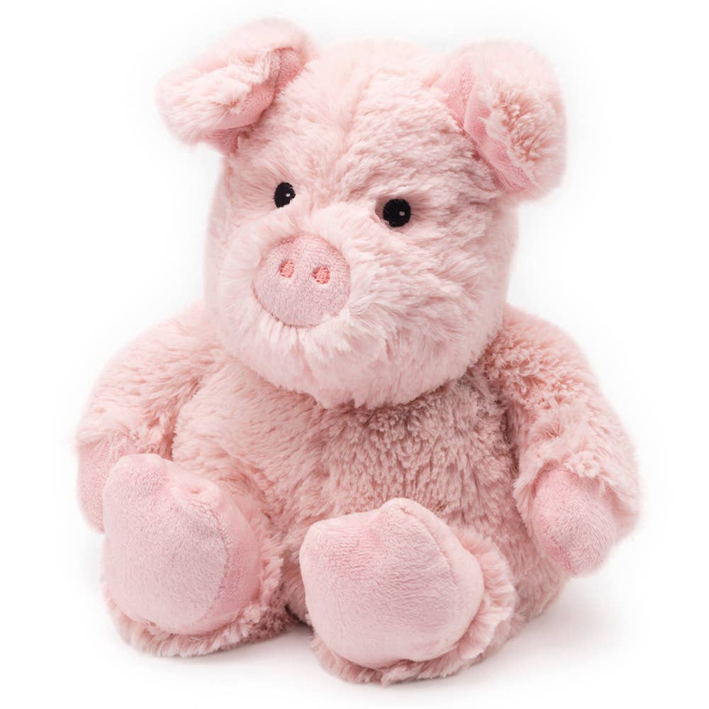 A close-up of a pink Warmies® Pig plush toy, ideal for gentle relief with French lavender scent. Microwave-safe for soothing warmth.