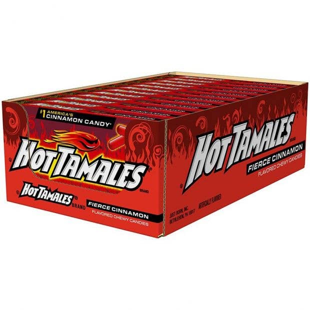 A display box containing multiple packets of Grandpa Joe's Candy Shop brand Hot Tamales 5oz Theater Box, Fierce Cinnamon Candy 12ct. The packaging is predominantly red with bold white and yellow lettering and fiery graphics, emphasizing the spicy chewy candy flavor.
