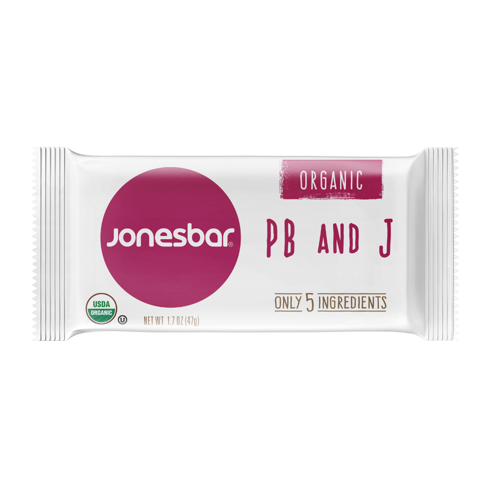 Jonesbar PB+J Peanut Butter & Jelly Organic Energy Bar 1.7oz packaging: white with purple and pink accents, red circle, pink circle, and green circle with text. USDA Organic, Gluten Free, Vegan.