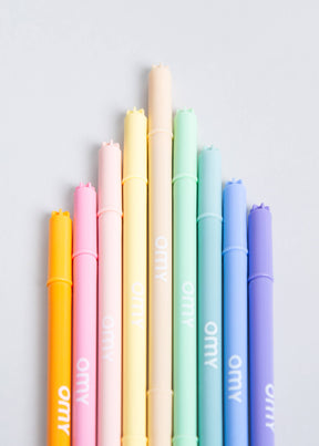 Nine dual-tip pastel markers in a box that doubles as a holder, showcasing soft and vibrant colors, perfect for coloring and drawing. Made in Italy.