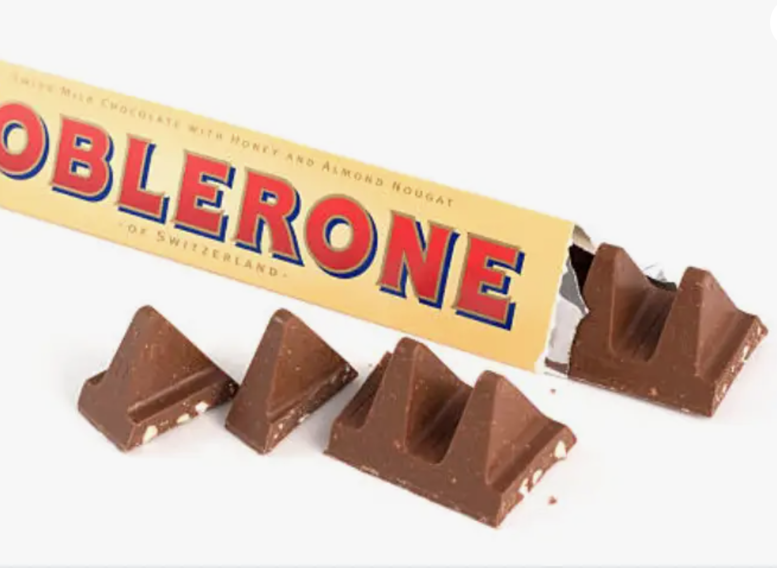 Toblerone Swiss Milk Chocolate 100g: A chocolate bar with triangular top design, white specks, and pyramid shapes on a white surface. Perfect for gifting on special occasions.