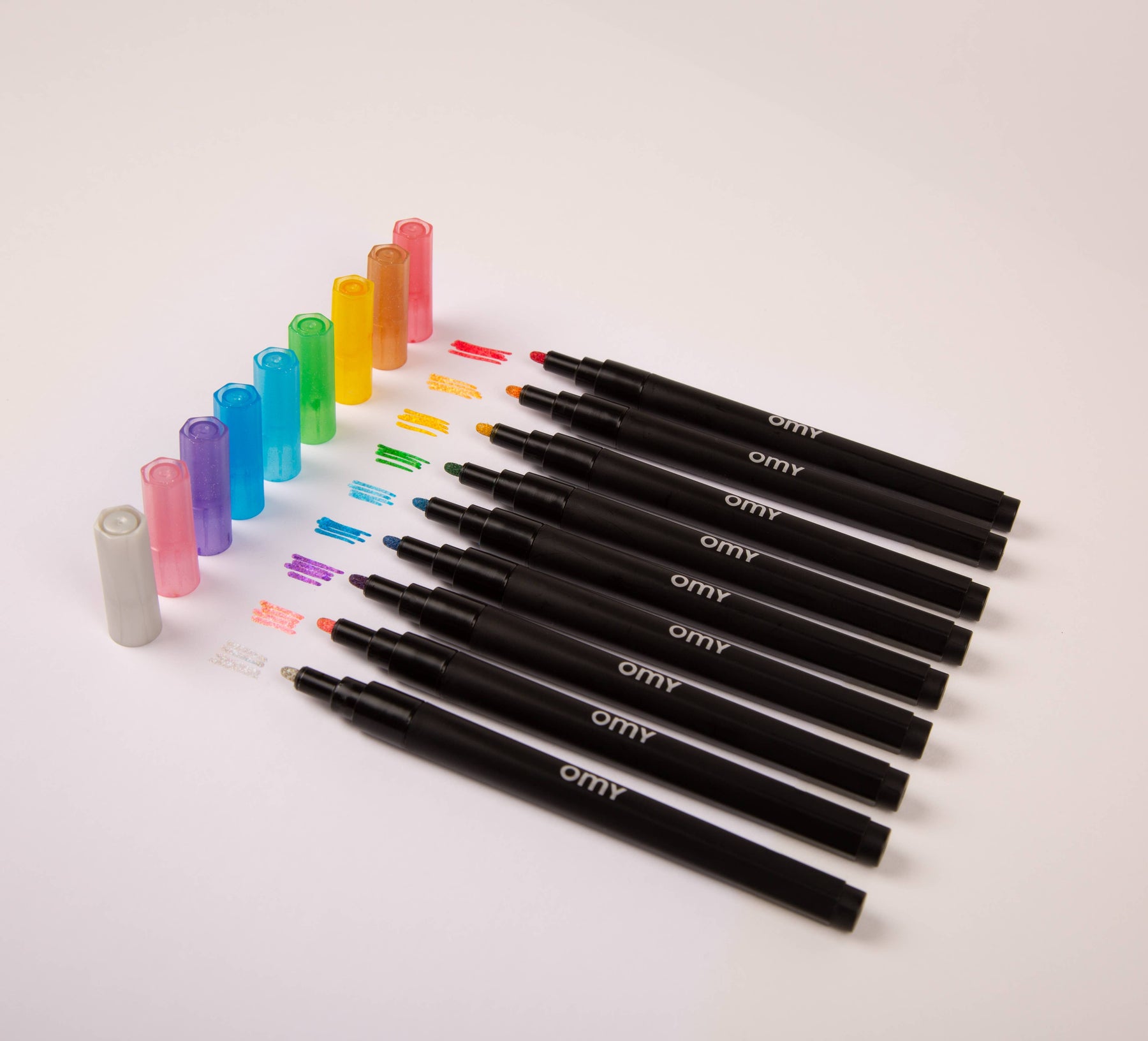 A row of glitter markers in vibrant colors, including blue, violet, yellow, silver, green, and pink. Shimmery and waterproof, perfect for adding sparkles to drawings on various surfaces.