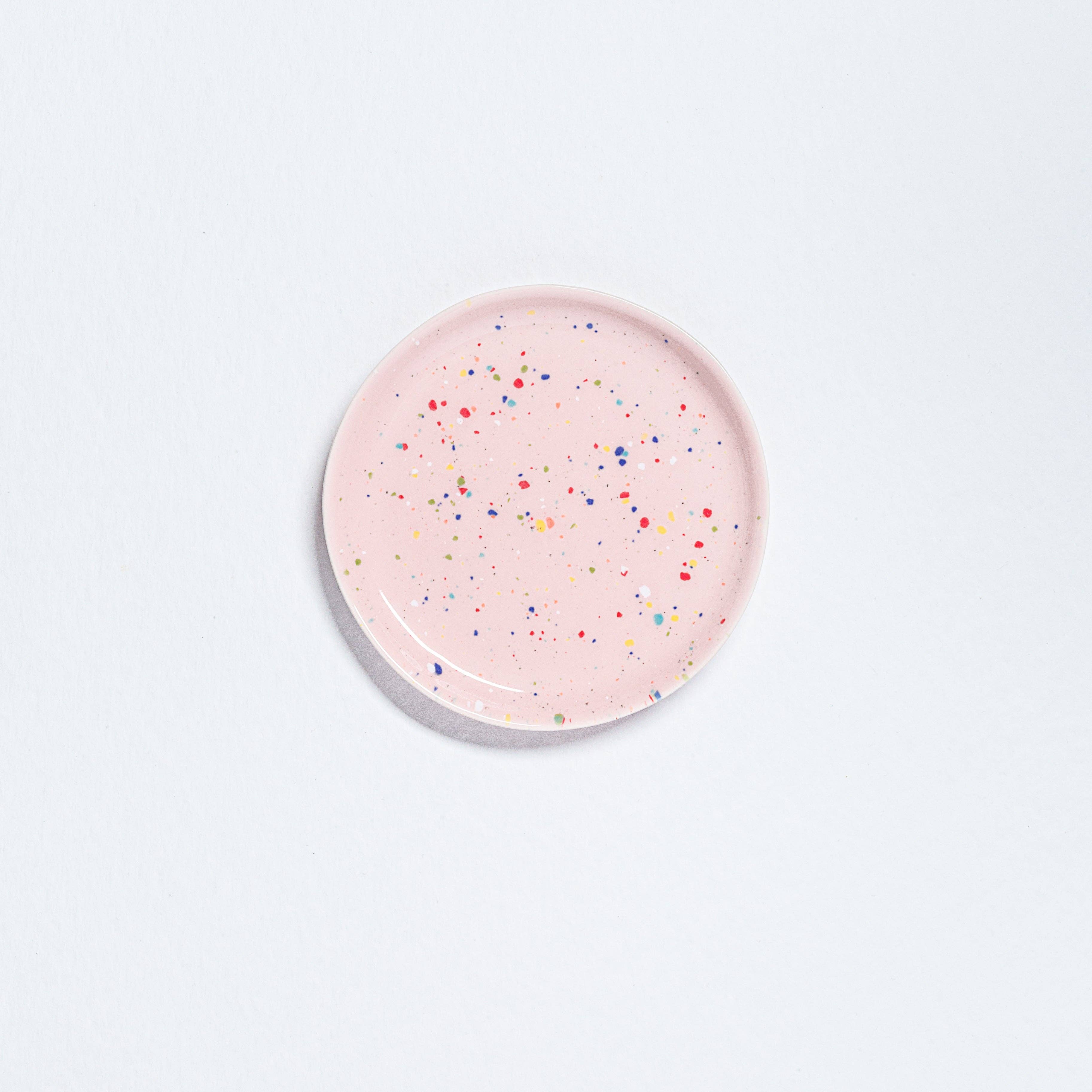 Delightful Party Bread Plate, 17cm diameter, 1.6cm height, pink with multicolored specks. Artisan-crafted, dishwasher and microwave safe, food safe, Cadmium Free. Unique design from our vibrant Party collection.