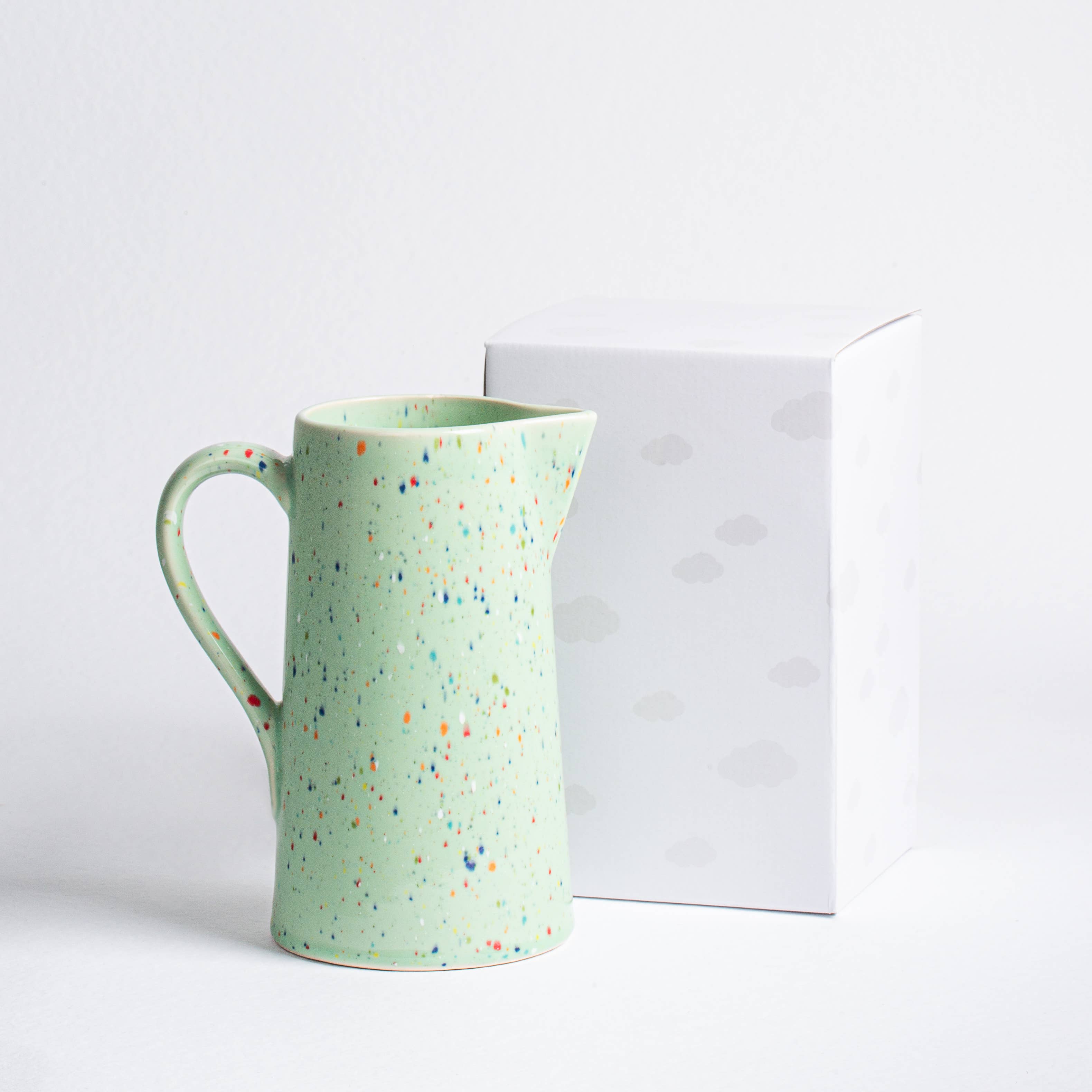 A ceramic pitcher with a shiny glaze finish, perfect for everyday use. Dimensions: L18cm x W12.5cm x H22cm, Capacity: 1.5L. Dishwasher and microwave safe, food safe, Cadmium Free. Unique artisanal piece.