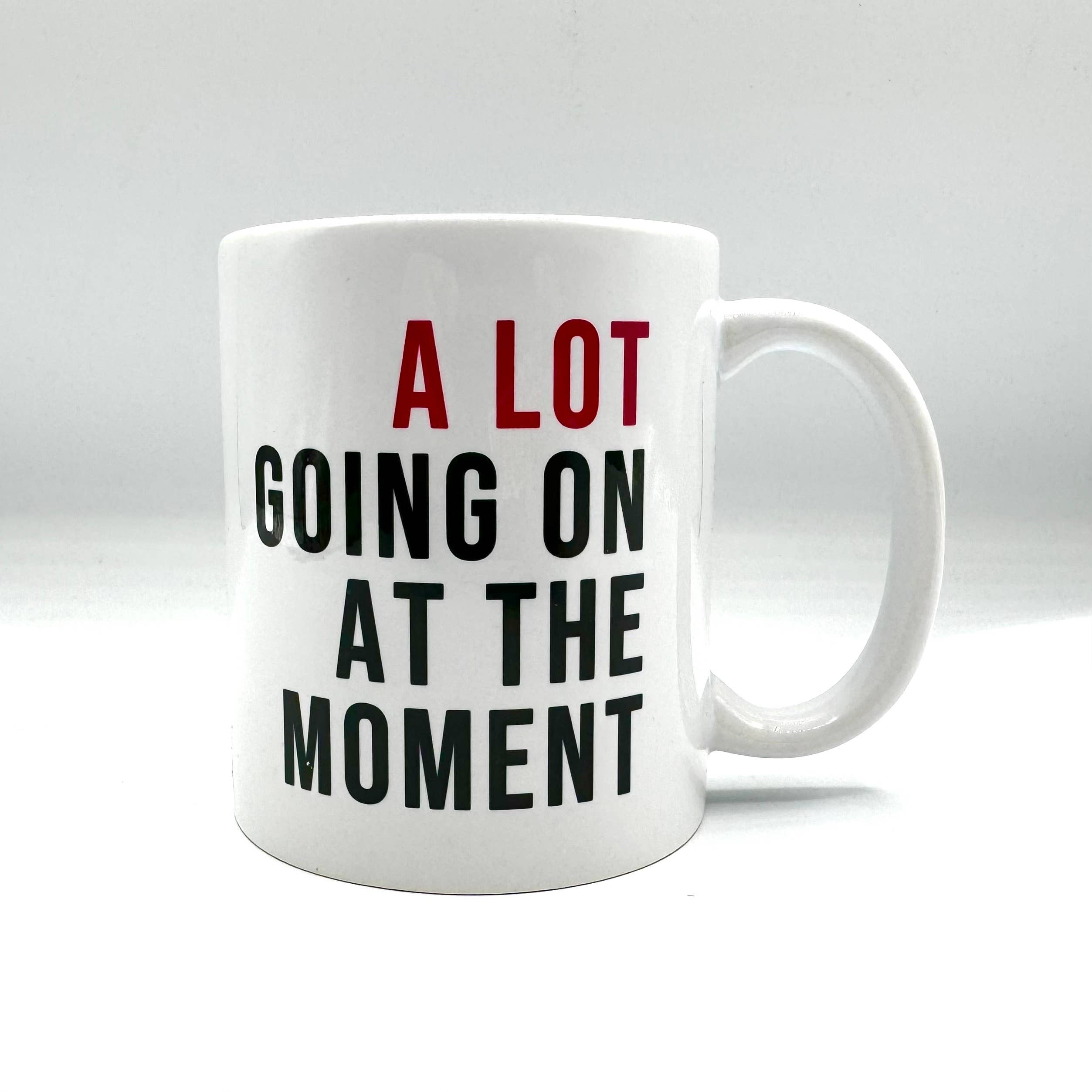 A Lot Going On At The Moment Mug: White mug with Taylor Swift inspired art, 11 oz., C-shaped handle, dishwasher & microwave safe, design on both sides.