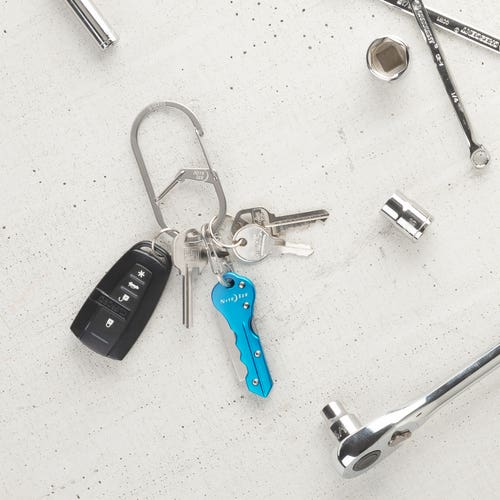 Dual chamber carabiner for keys, featuring stainless steel construction. Securely holds various key types, including fobs and international keys. Allows easy attachment to belts or bags. Sizes cater to different key needs.