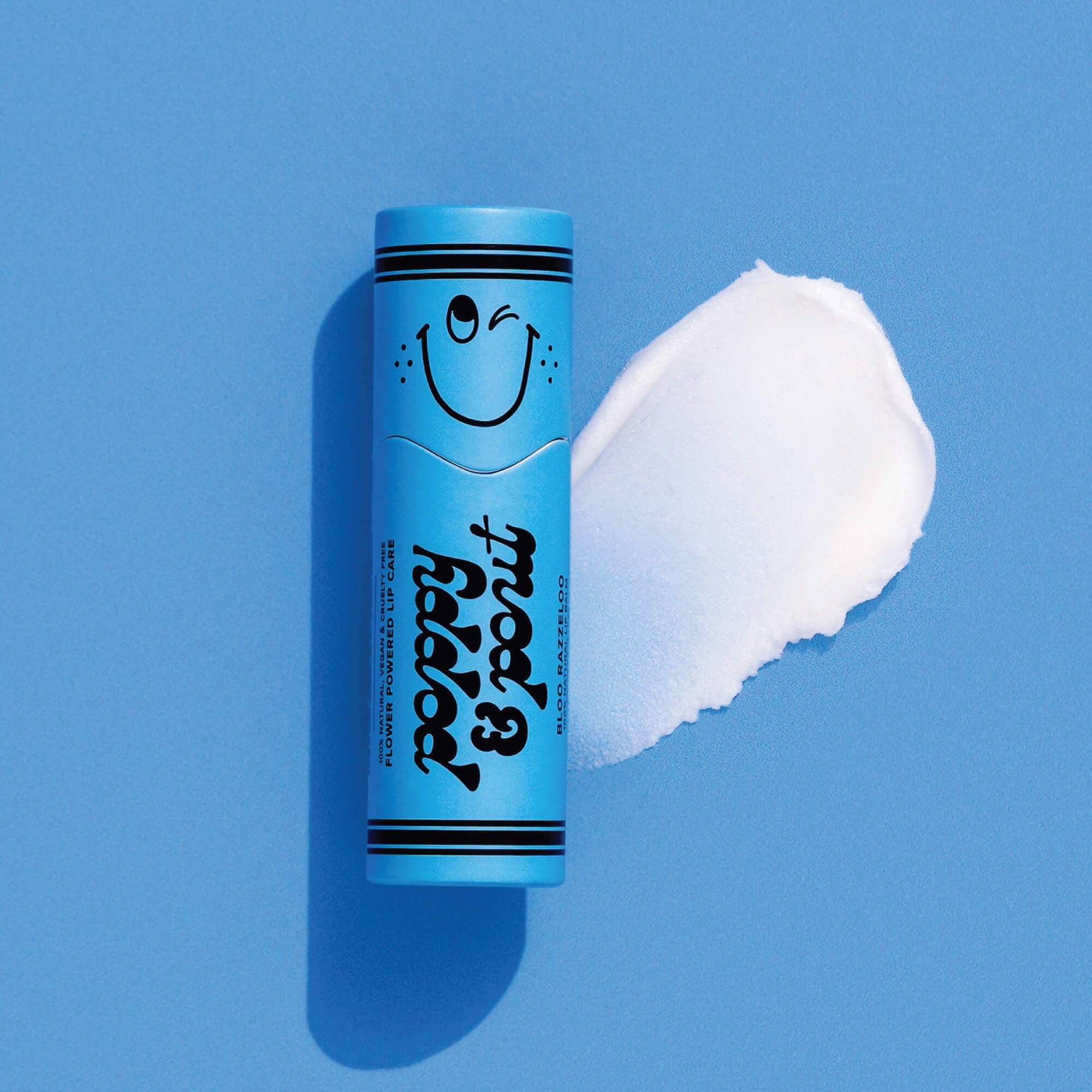 Close-up of a blue tube with a smiley face, showcasing Lil' Poppies Bloo Razzeloo lip balm. Fun, fruity flavors for kids.