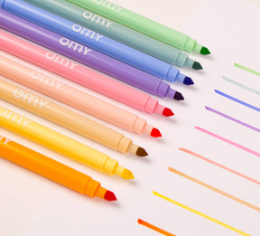 Nine dual-tip pastel markers in a box that doubles as a holder, showcasing soft and vibrant colors for creative coloring and drawing, made in Italy.