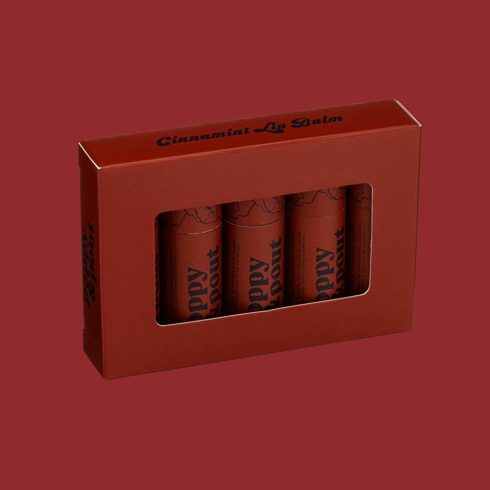 Cinnamint Lip Balm box with red cylinders, can, and bottle. Handmade in Idaho with 100% natural ingredients. Leaping Bunny certified cruelty-free. Tester included.