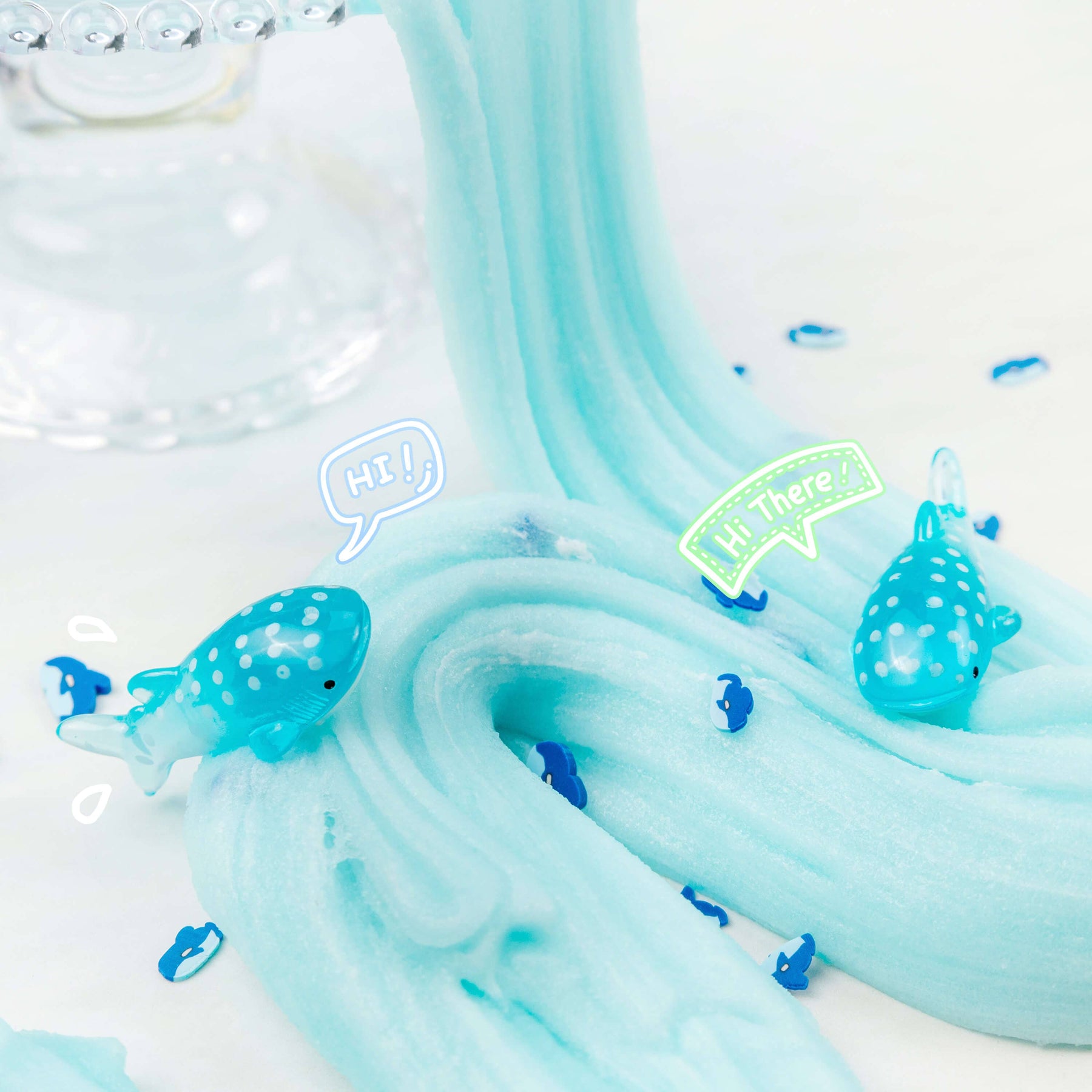 Gummy Shark Jelly Creme Slime with shark fimo slices, whale shark charms, and Meringue Slime swirls, creating a cool, creamy texture scented like blue raspberry candy and marshmallow cream.