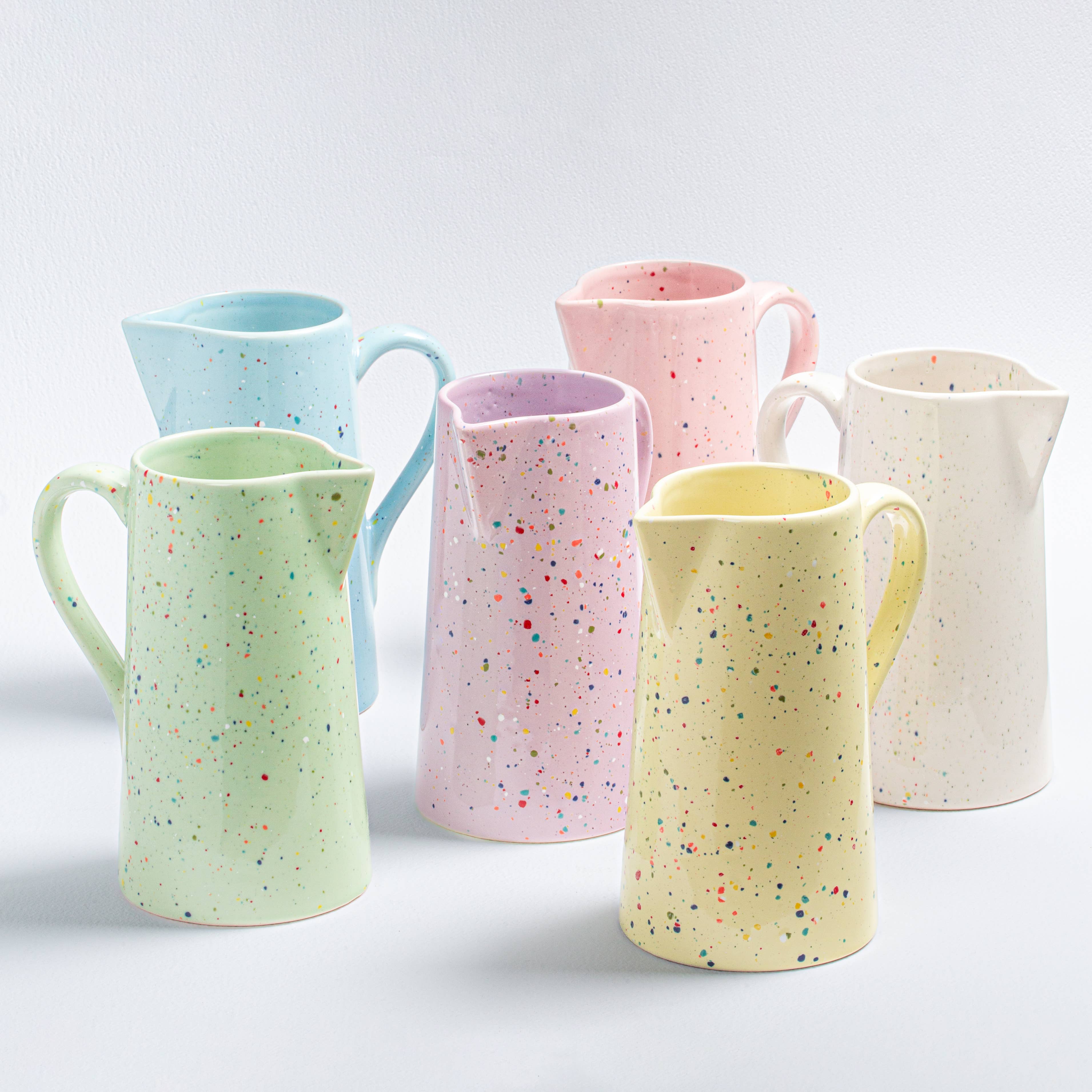 A vibrant ceramic pitcher, perfect for everyday use. Shiny glaze finish, 1.5L capacity. Artisanal process ensures unique design. Dishwasher and microwave safe. Celebrate individuality with this New Party Pitcher.