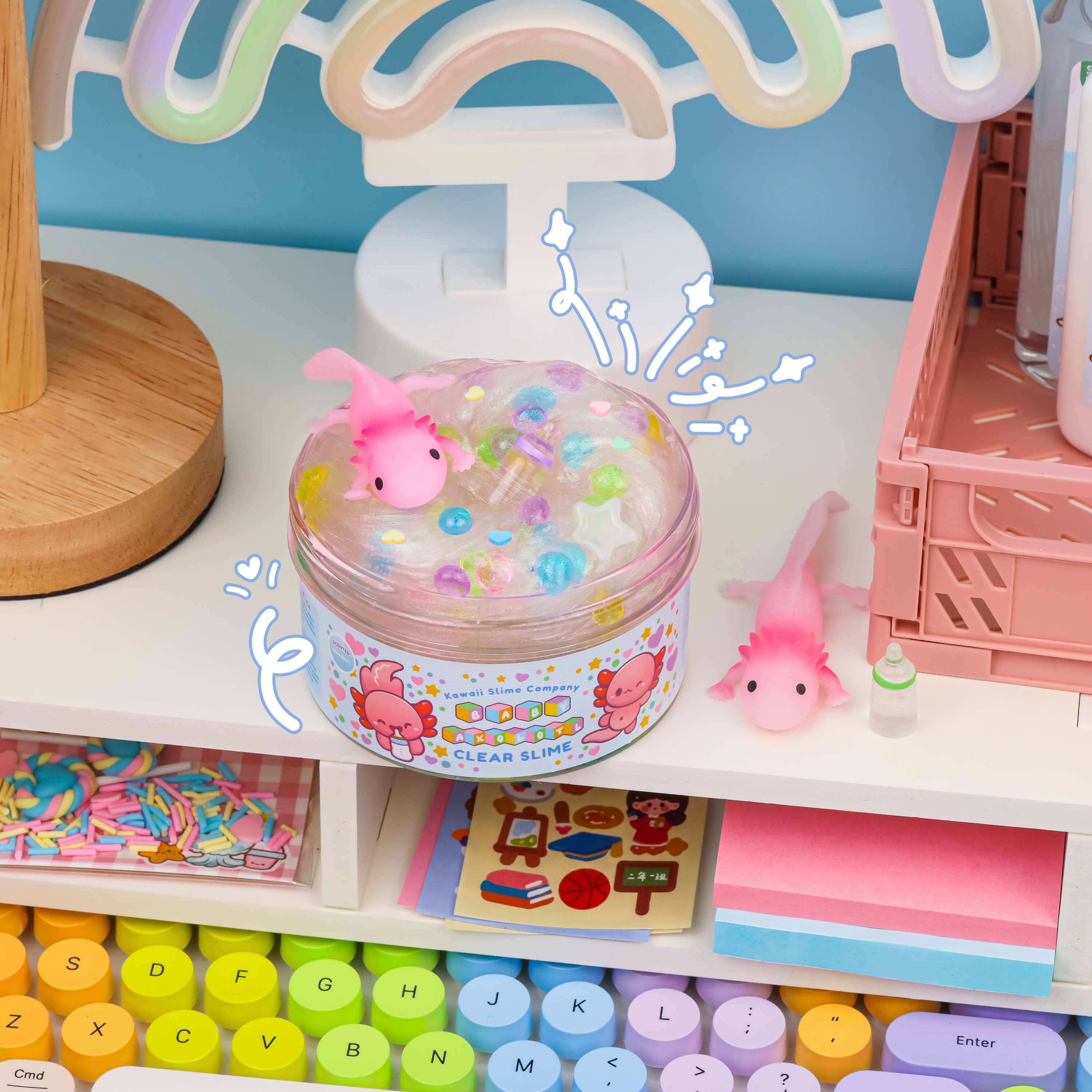 Four clear slime containers featuring baby axolotl figures, creating a whimsical underwater scene. Ideal pet-themed toy for endless fun and carefree play.