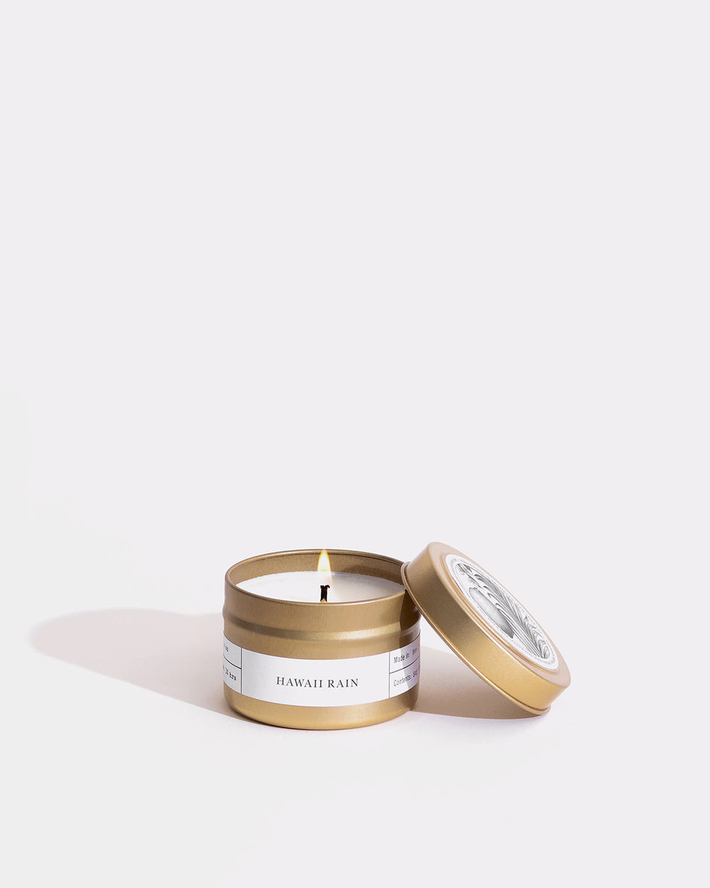 A gold travel candle in a cocktail tumbler, inspired by Hawaiian rainforest scents. Eco-friendly soy wax, lead-free wick, vegan, cruelty-free. Made in Brooklyn.