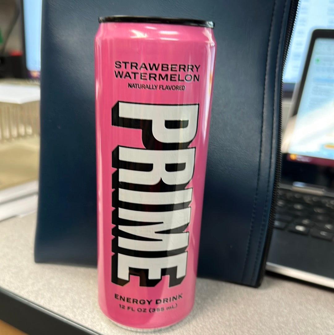 A close-up of Prime Strawberry Watermelon energy drink in a pink can with white text, featuring a sleek design and refreshing flavor.