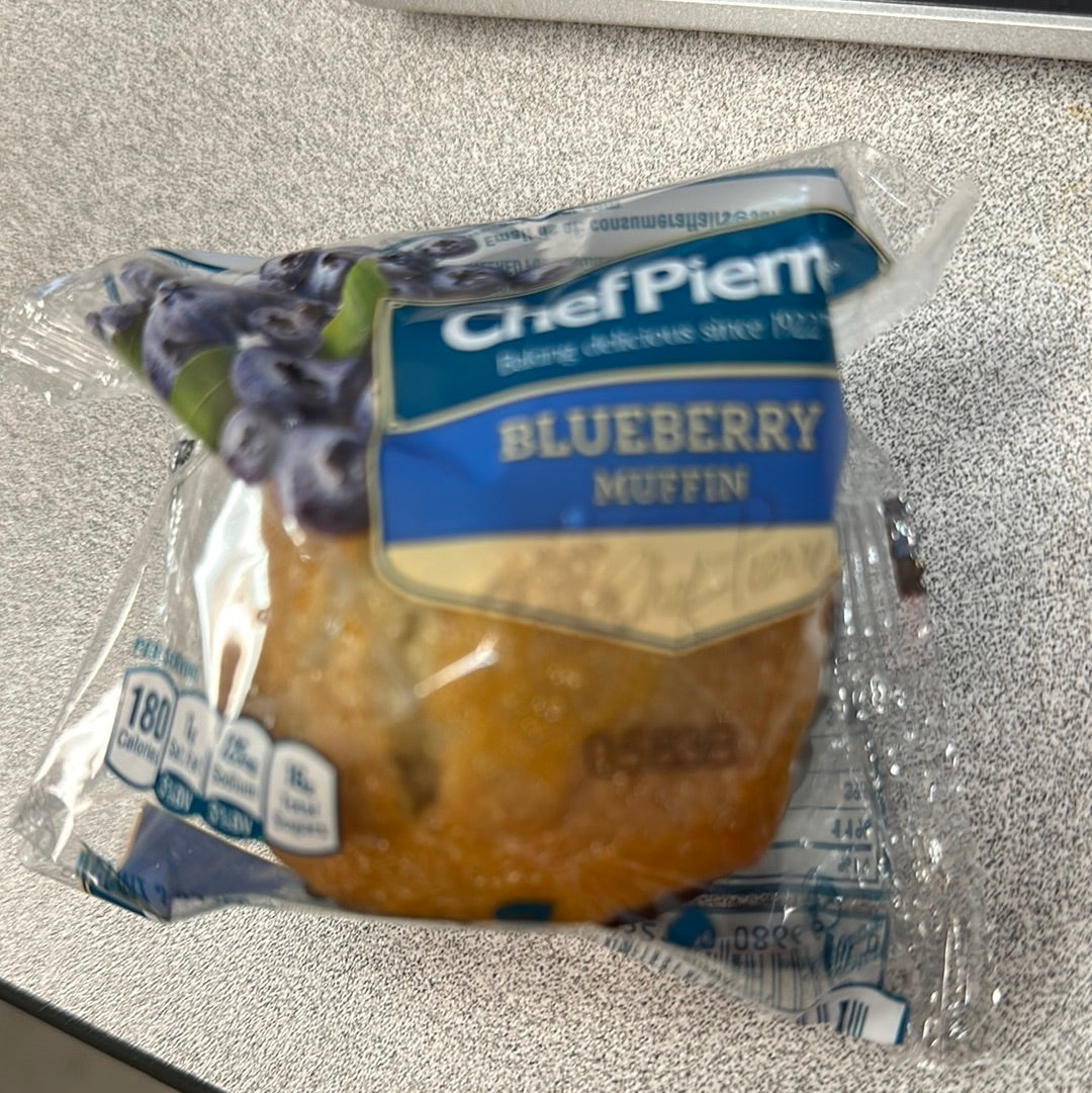 A close-up of a bag with Chef Pierre Blueberry Muffins wrapped in plastic, ready to enjoy as a delicious snack.