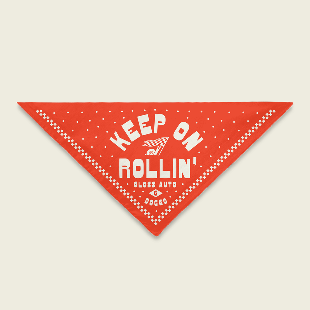 A red Dog Bandana with white text, featuring a one-sided print and hemmed edges. Care: Cold delicate cycle, hang dry, no bleach.