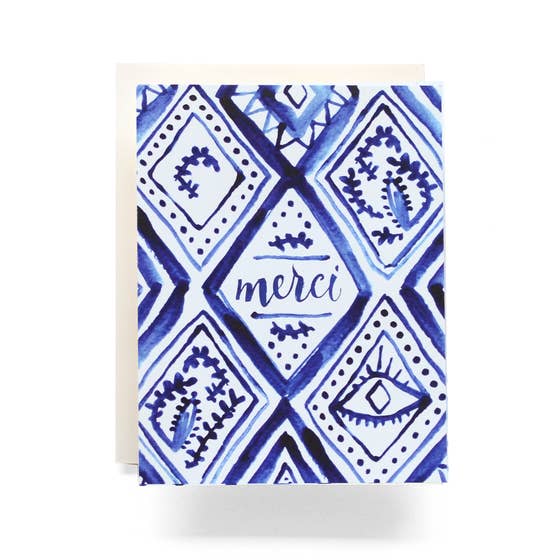 A folded A2 greeting card featuring a blue and white pattern, with a close-up of an eye design. Cream envelope included. Made in the USA.