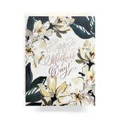 A Magnolia Mother's Day card featuring intricate flower drawings, a black and white pattern, and a close-up of flowers on a folded 4.25x5.5 card with a cream envelope. Made in the USA.