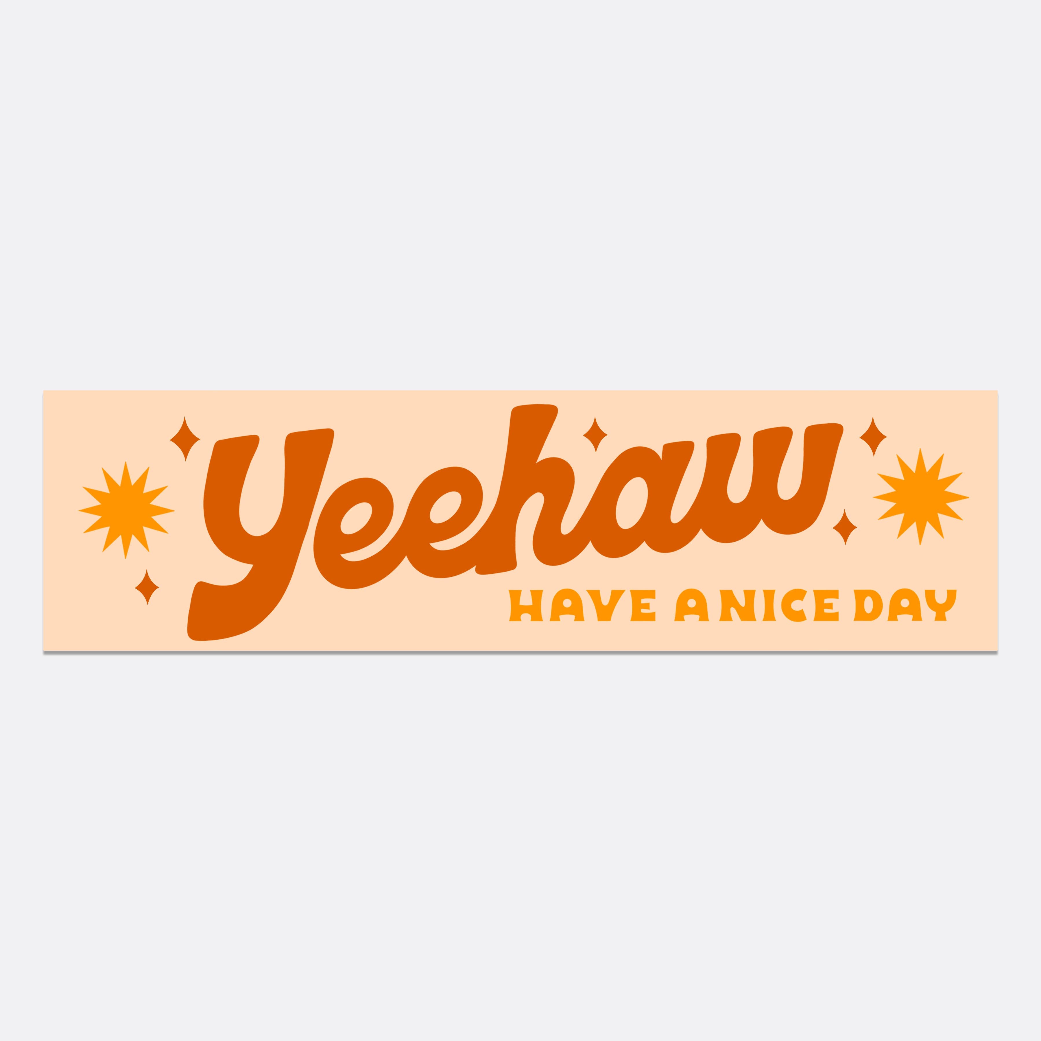 A rectangular waterproof bumper sticker with the text Yeehaw in orange, featuring a yellow star and a red heart. Measures 11in x 3in.