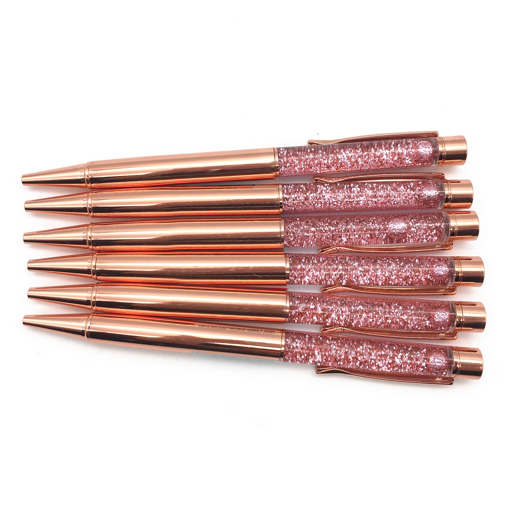 A group of rose gold liquid glitter pens, close-up of copper tubes, and a person's head. Product: Liquid Glitter Pen Set of 6, refillable for custom blends with acrylic displays.