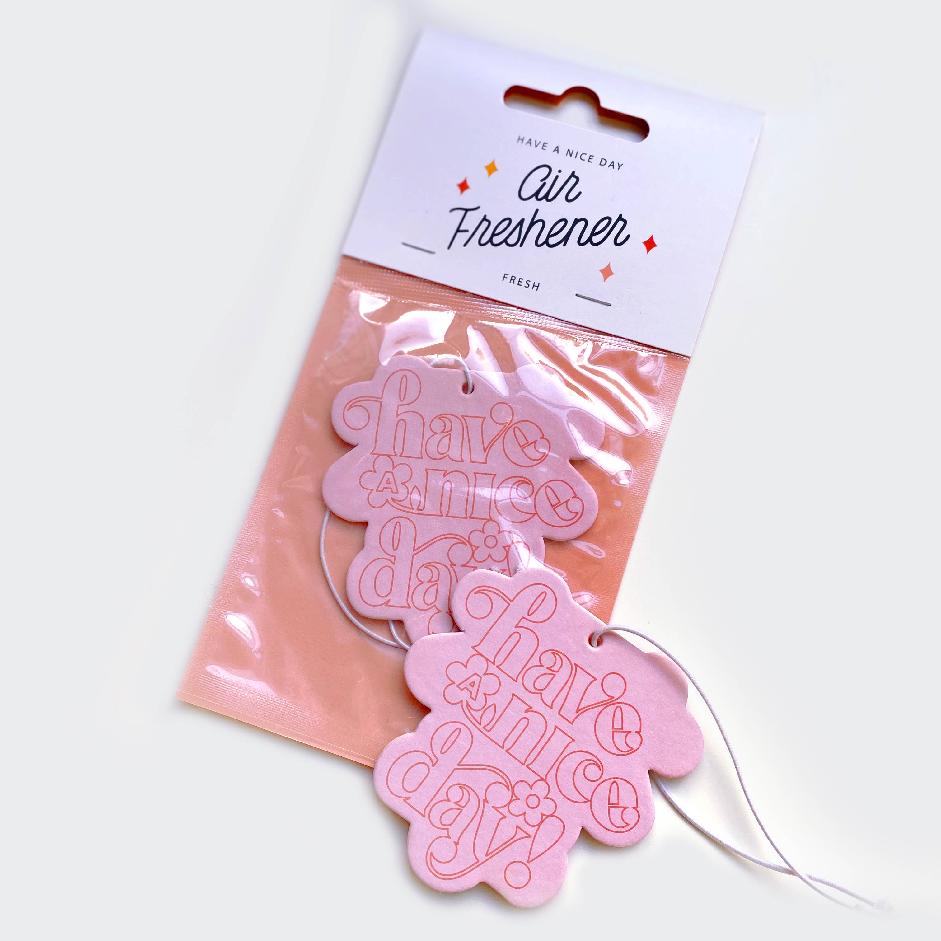 Classic Have A Nice Day Air Freshener with fresh smell, 3.25in x 3.5in, double-sided print, in a white package with pink tag and string.