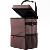 A sturdy XL car trash can in brown Oxford fabric with black strap and metal clip. Waterproof, durable, and collapsible-proof for a mess-free car experience.