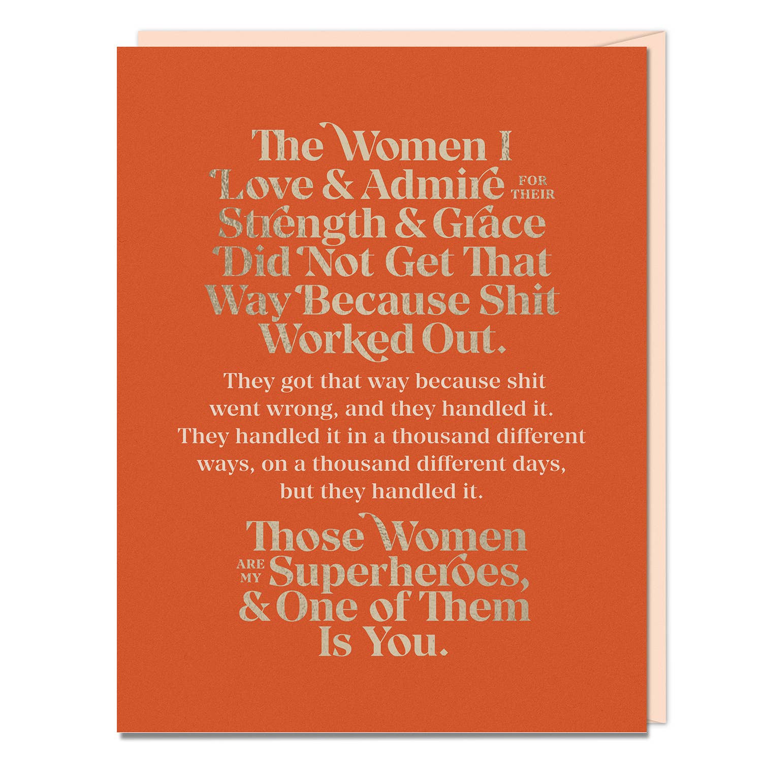 A card by Elizabeth Gilbert with white and orange text on a red background. Features foil stamping, colored envelope, A2 size. Empowering message celebrating strong women.