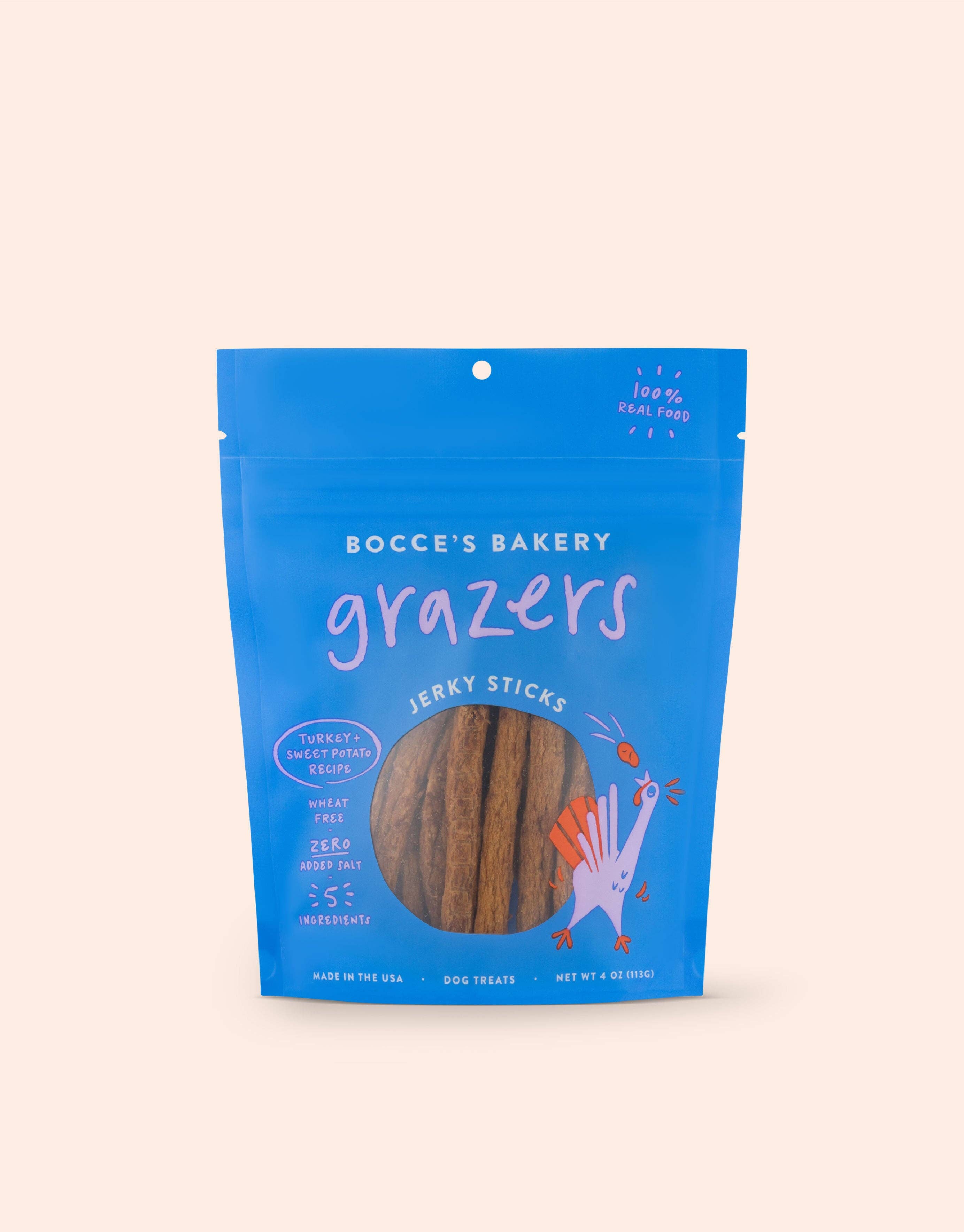 A blue bag with a logo and a stick inside, showcasing Grazers Turkey & Sweet Potato Jerky Sticks, made in the USA with all-natural ingredients like turkey, sweet potato, and more.