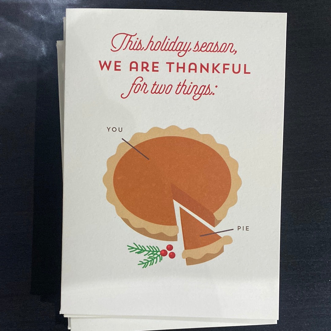 A stack of cards featuring a pie illustration, one card with text, and a piece of pie with a slice missing, reflecting the Minted We Are Thankful product theme.