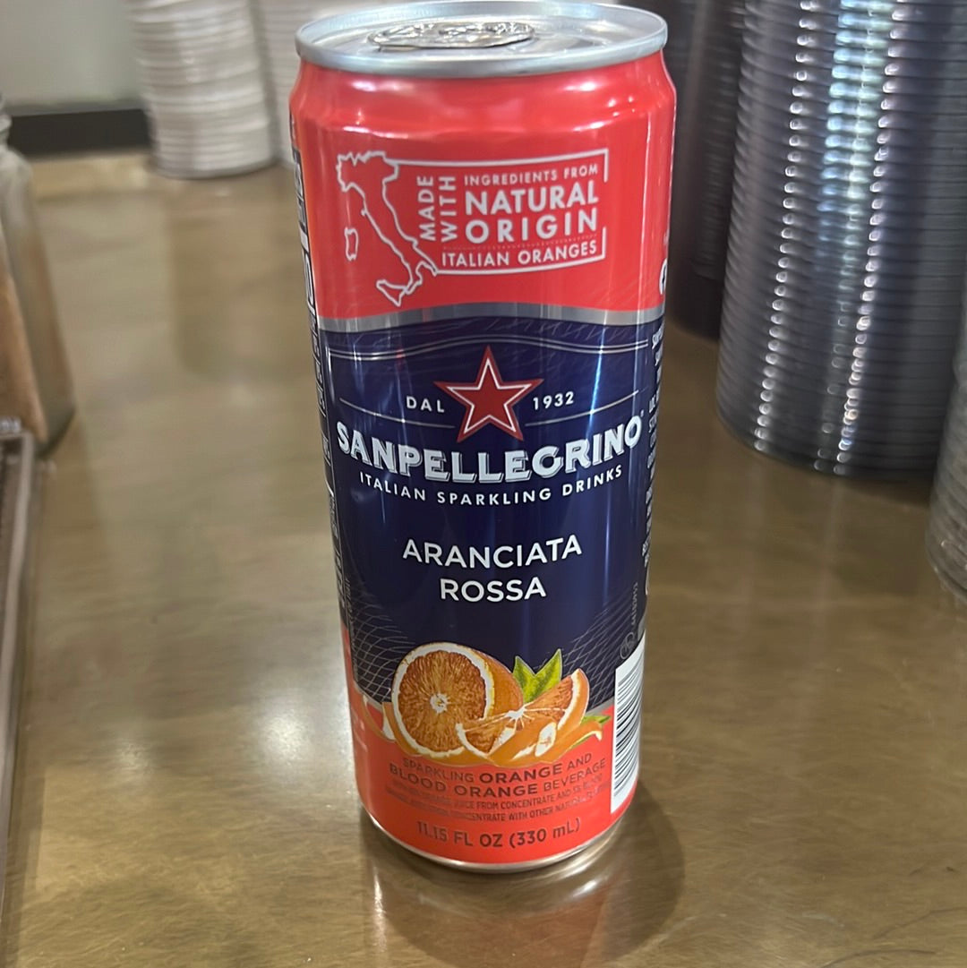 A can of Sanpellegrino Aranciata Rossa, a citrus soft drink, on a table.