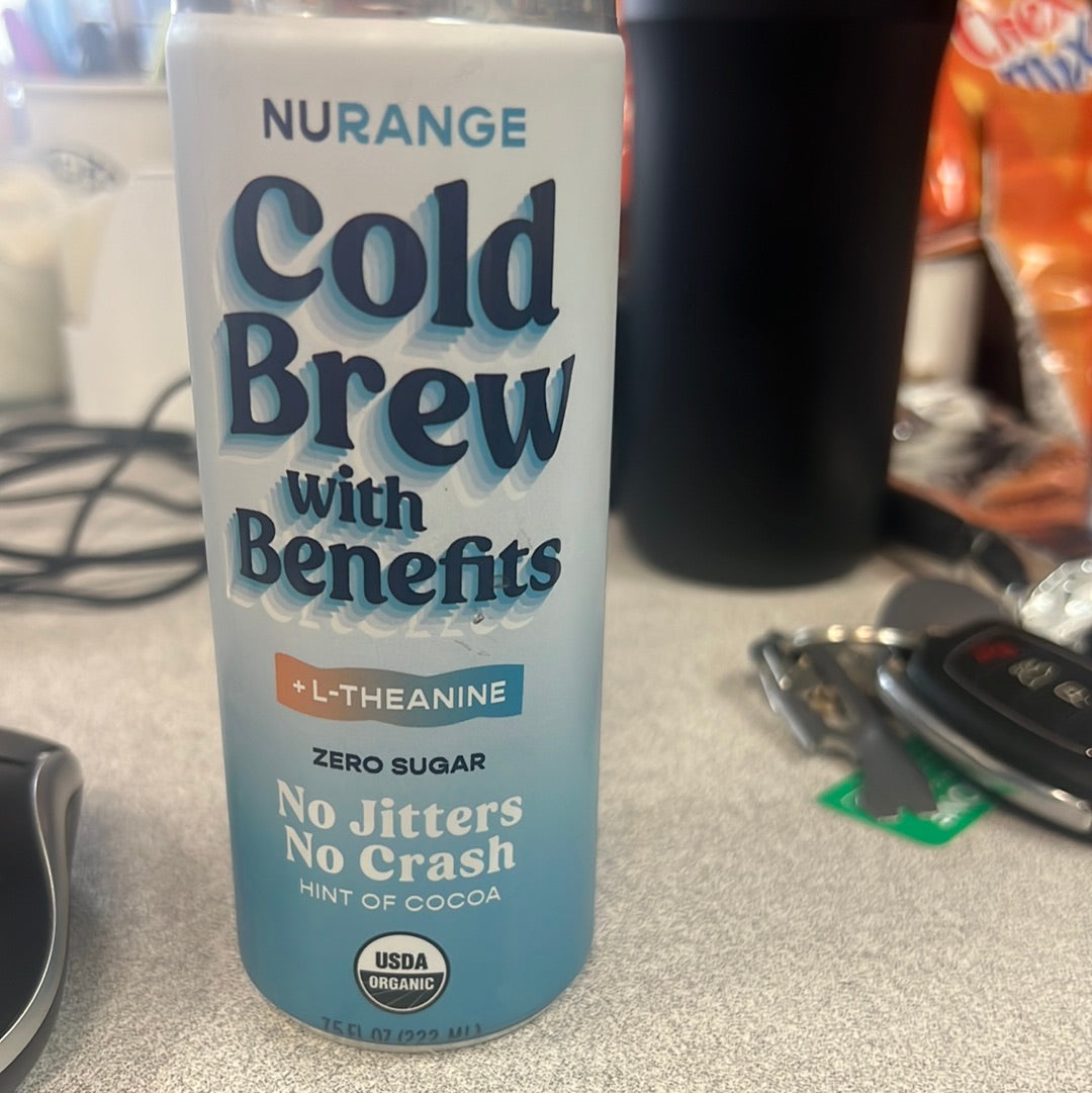 A close-up of Nurange Cold Brew, a tin can of soft drink on a table. Prominent label visible.