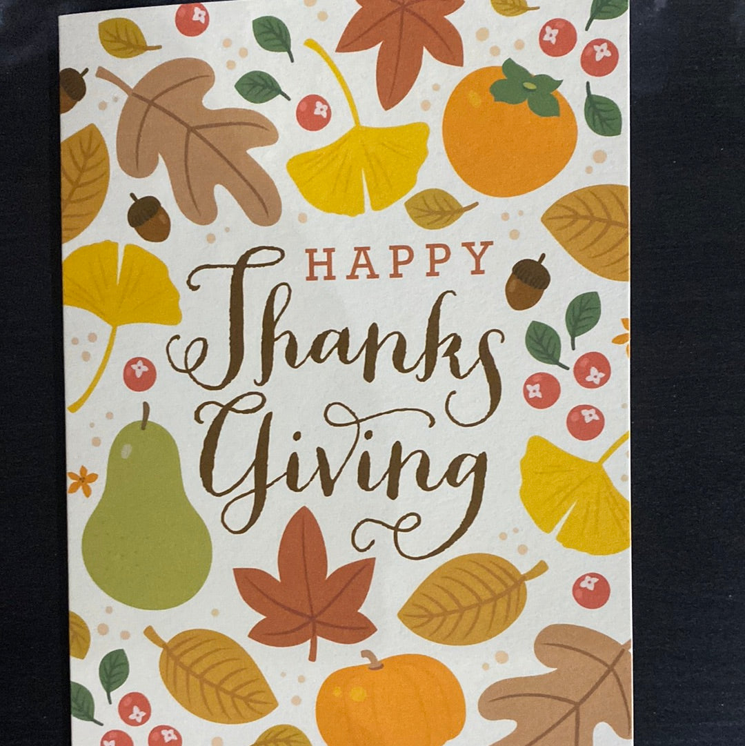 A card featuring a pattern of leaves, fruits, yellow leaf with red and orange leaves, yellow and white flower, pumpkin with a sticker, and brown leaf on white surface, embodying the essence of Minted Thanksgiving.